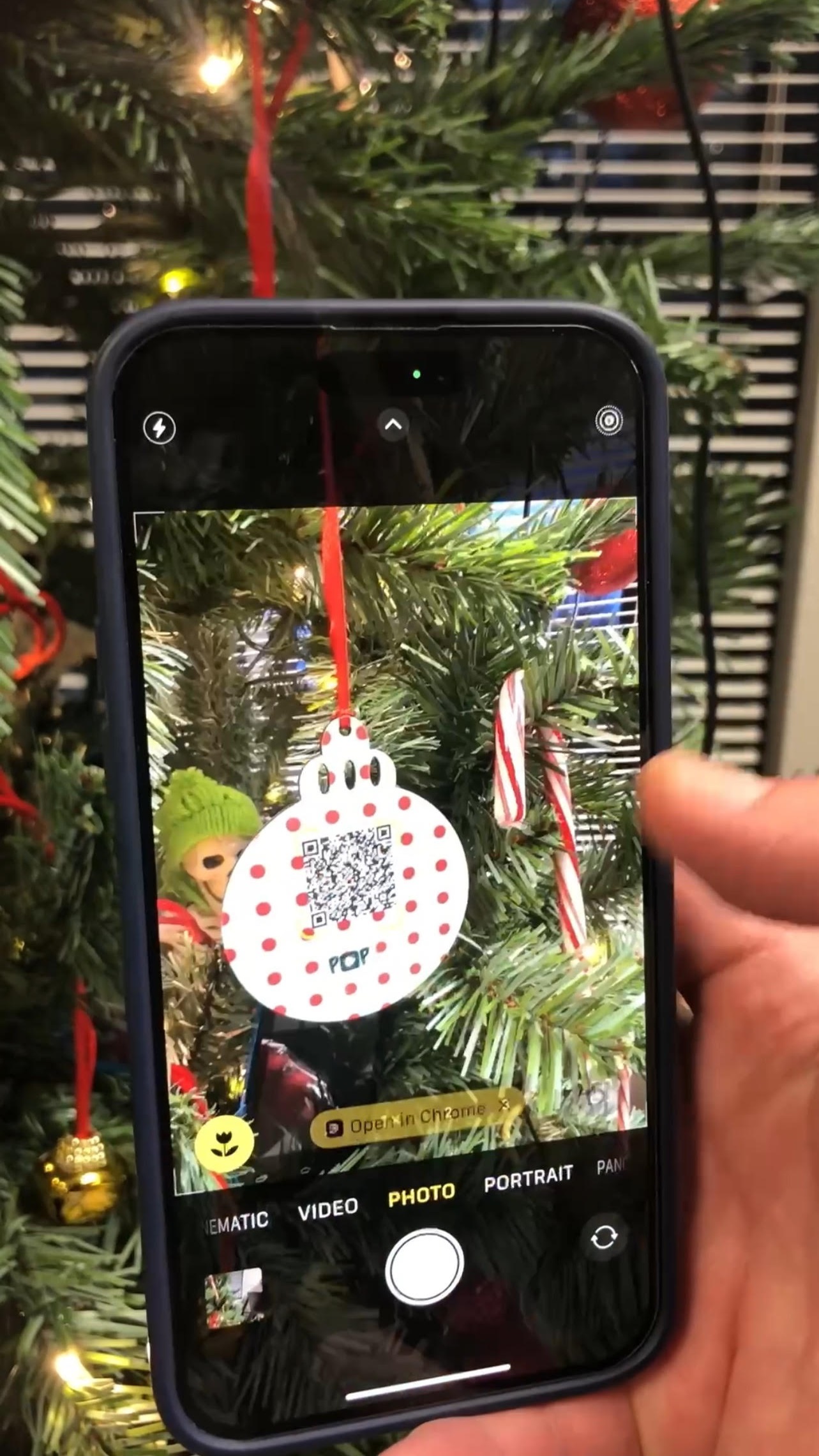 Pop Video Ornament being scanned on Christmas tree